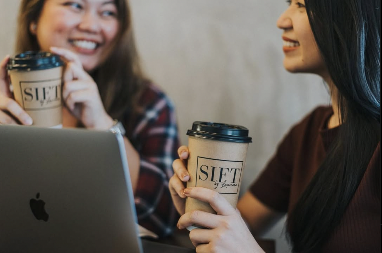 two girls drinking coffee